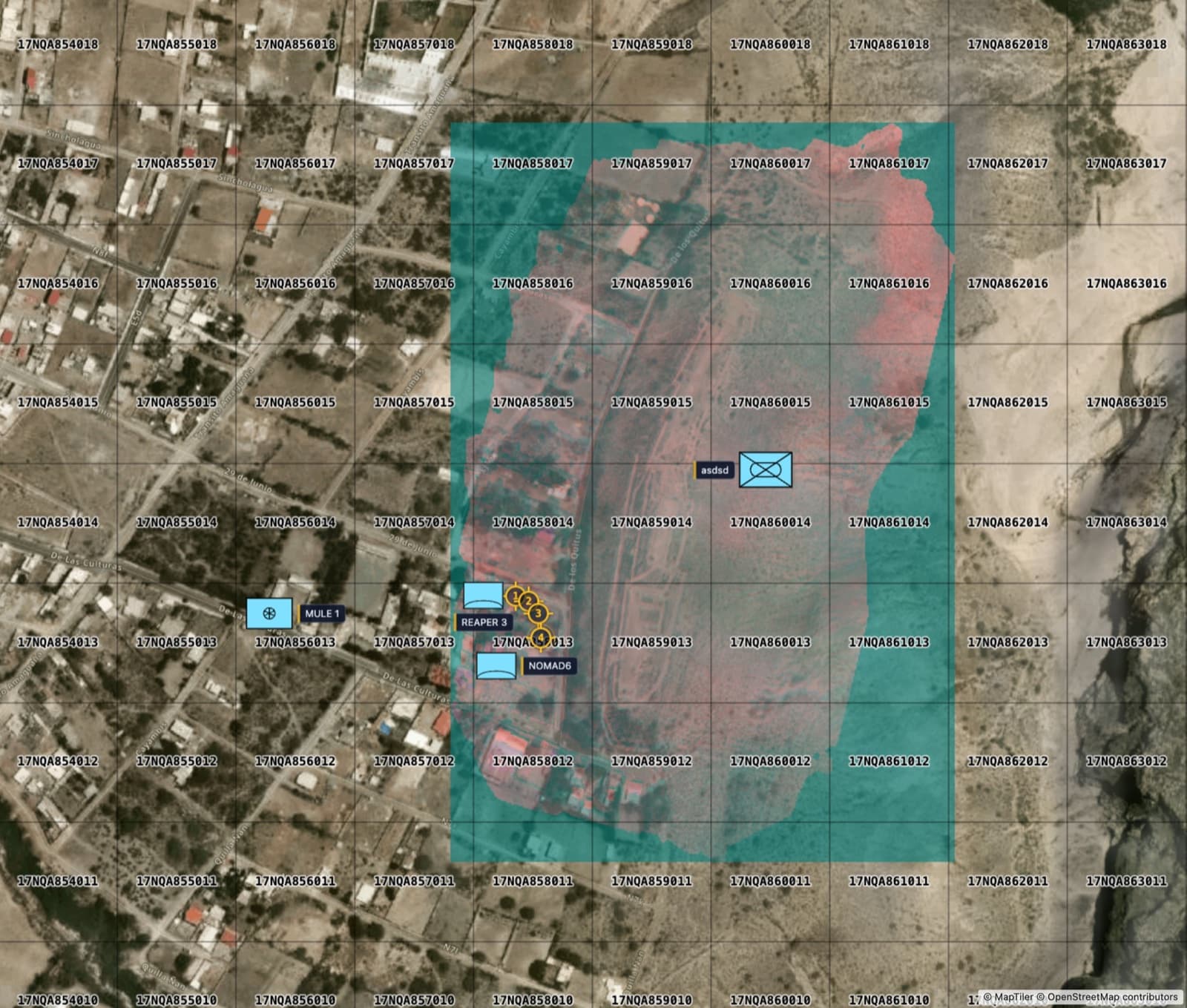 A drone orthophoto anchored on the map under a labeled MGRS grid, with friendly unit symbols MULE 1 and NOMAD6, hostile air defense markers ADA 1 and ADA 2, and numbered objective markers placed on the imagery.