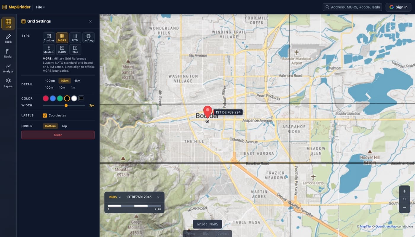 MapGridder with the grid panel open in MGRS mode over a map of Boulder, Colorado, bold grid lines crossing the city and a waypoint pin labeled with the six-figure reference 13T DE 769 294.