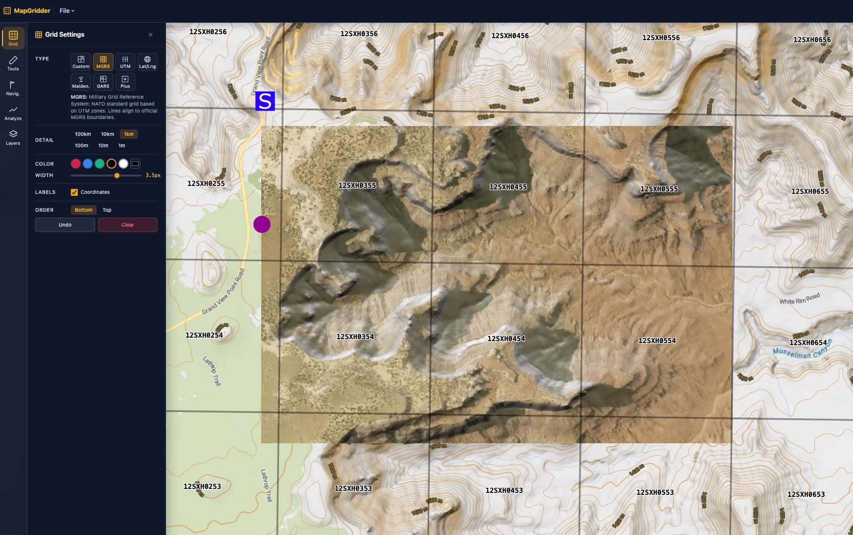 An aerial image anchored over a topographic basemap with contour lines and a 1 km MGRS grid on top, every square labelled with its grid reference, with a staging symbol and a helispot marker at the edge of the imagery.
