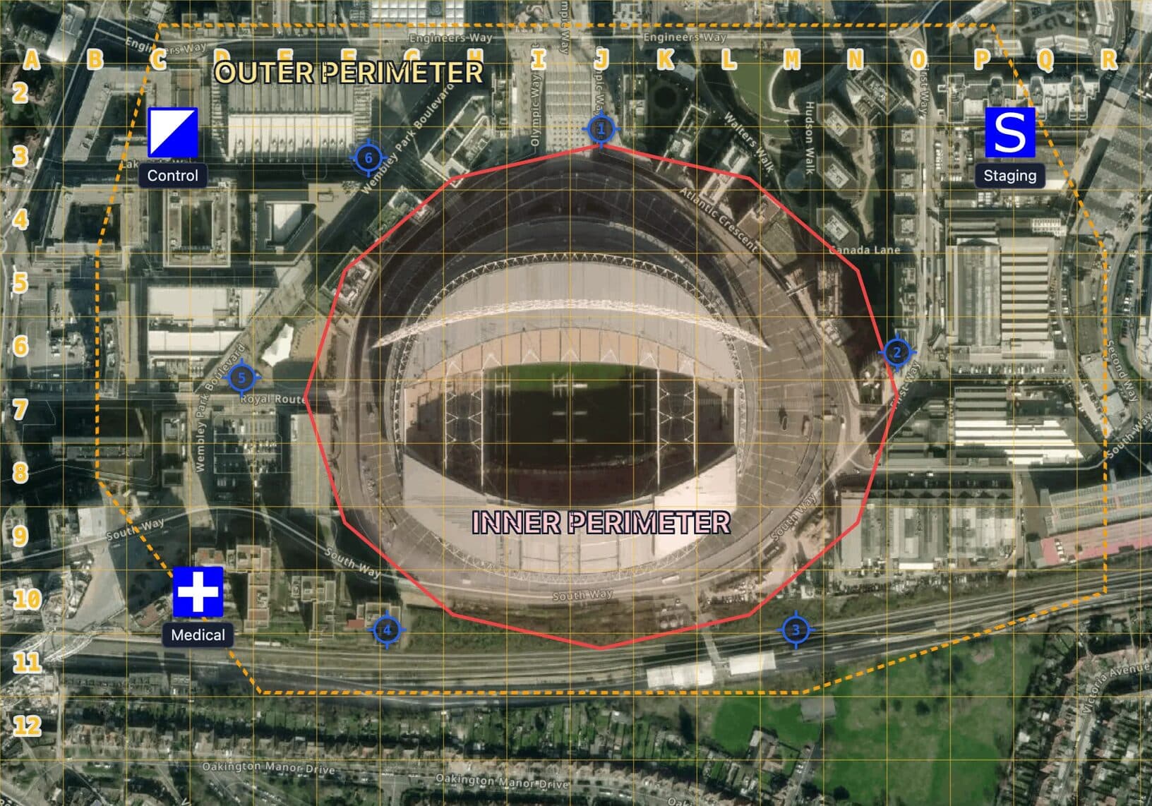 Security site plan map of a stadium on satellite imagery in MapGridder: a dashed amber outer perimeter around the surrounding streets, a red inner perimeter around the bowl, a lettered and numbered 50 meter grid, six numbered blue post markers at the gates, and symbols labeled Control, Medical and Staging.